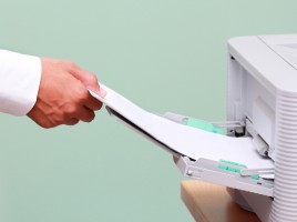 Man adding paper to printer